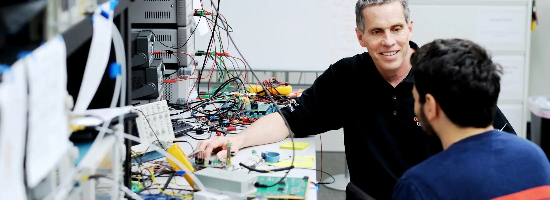 Tom Weller working on a project with a student