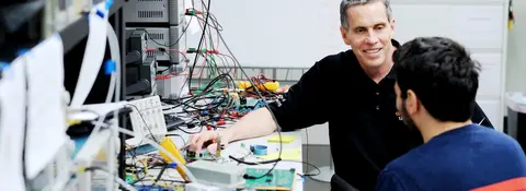 Tom Weller working on a project with a student